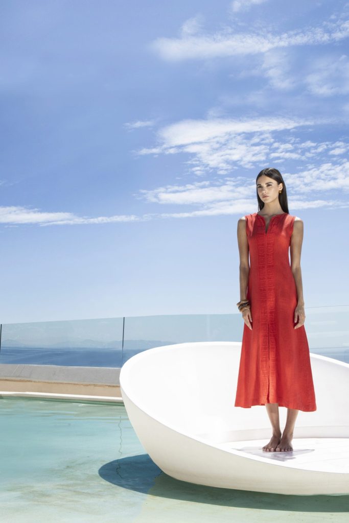 Woman in a red linen dress by the pool
