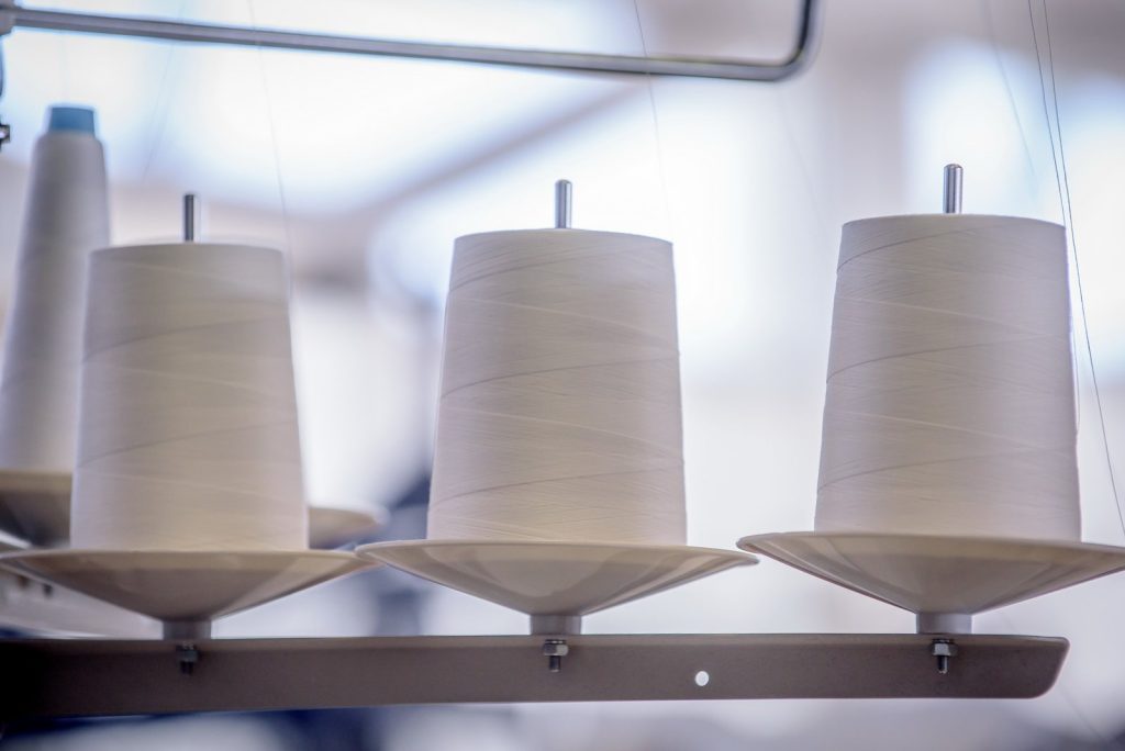 Spools of natural yarn in the workshop